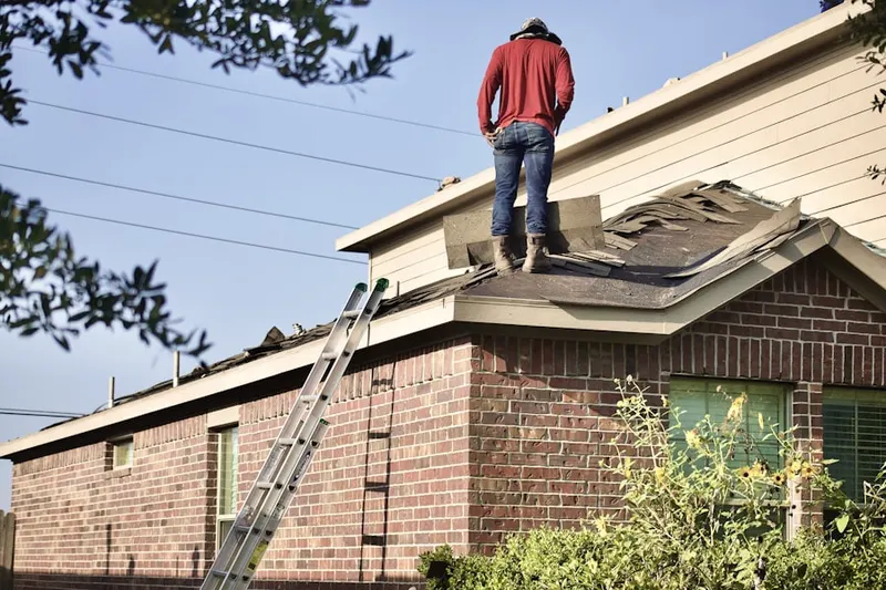 Professional roofer working on a residential roof in Edwardsville